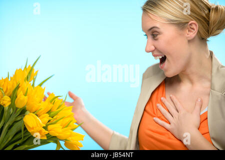 Surprised woman receive bouquet of yellow tulip flowers spring Stock Photo