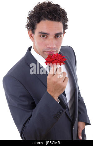 handsome man in suit  seduces with rose Stock Photo