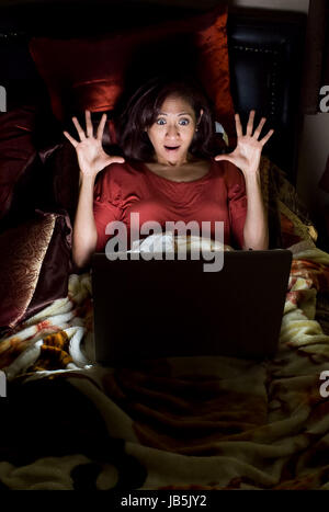 Attractive asian filipino woman on her bed Stock Photo