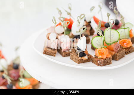 the buffet at the reception. Assortment of canapes. Banquet service. catering food Stock Photo