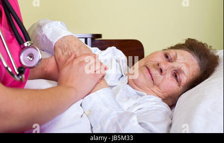 Picture of a bedridden elderly woman at home Stock Photo