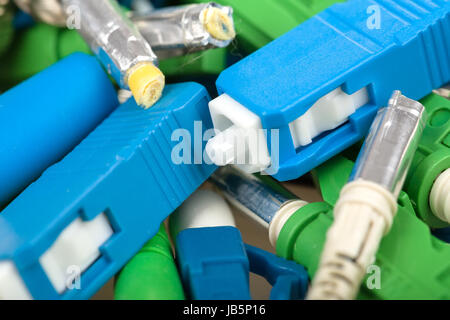 closeup of various types of fiber optic connectors, in front SC type Stock Photo