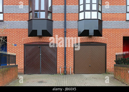 Closed Garage Doors Outside Of Residential Building Stock