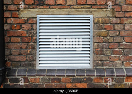 House ventilation grill on brick wall facade Stock Photo