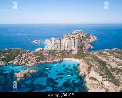 Aerial view of boats in front of Mortorio island in Sardinia. Amazing beach with a turquoise and transparent sea. Emerald Coast, Sardinia, Italy. Stock Photo