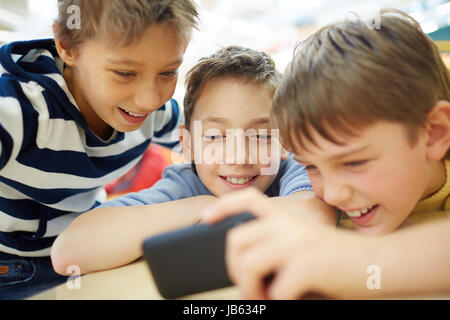Boys using a new smartphone Stock Photo