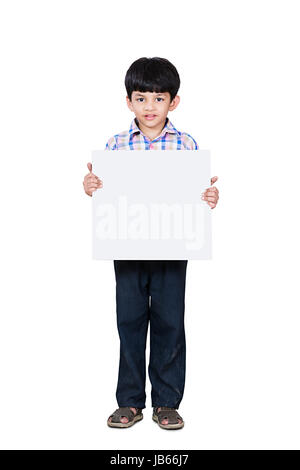 Happy 1 Indian Rural Kid Boy Showing White Board In Studio shot on White Background Stock Photo