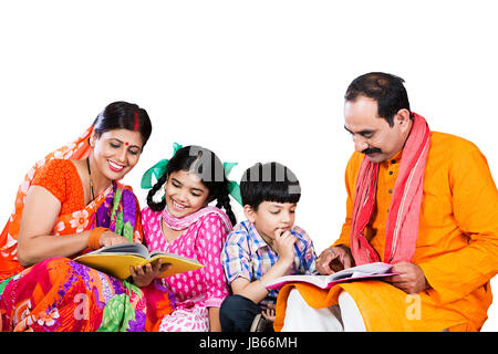 Indian Rural Farmer Family- parents helping 2 kids learn Books Teaching On White Background Stock Photo