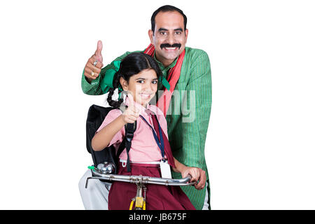 Happy 2 Indian Rural Father and Daughter going to school by Bicycle And Showing Thumbs up Stock Photo