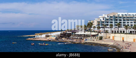 Rocky coast in Bugibba tourist city, Malta, Europe. Stock Photo