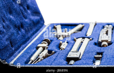 Drawing compasses lying on the table with the drawings Stock Photo