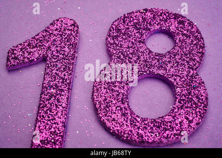 Number eighteen purple color over a purple background. Anniversary. Horizontal Stock Photo