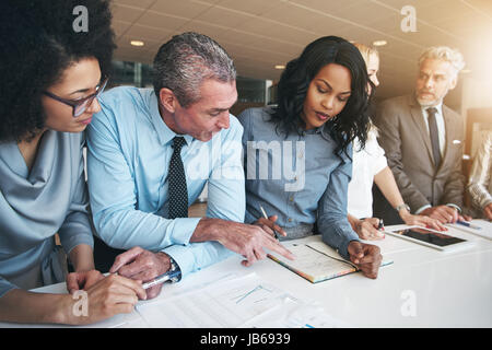 Black and white group of people doing teamwork in contemporary office. Stock Photo