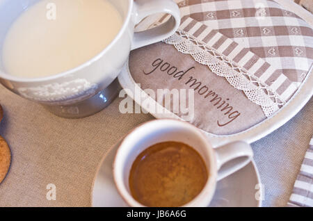 Table set for holidays or parties or for receptions, ready for breakfast with milk, coffee and cookies Stock Photo
