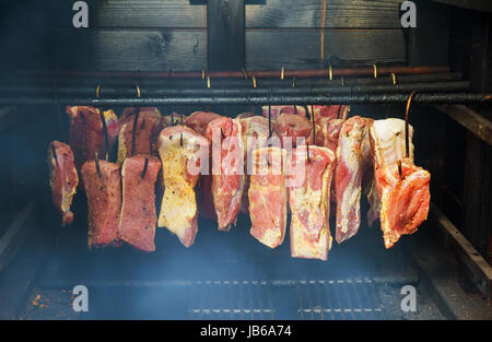 Ham, sausage in a homemade smokehouse Hanging smoked bacon for smokehouse Stock Photo