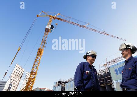 MODEL RELEASED. Construction workers on site. Stock Photo
