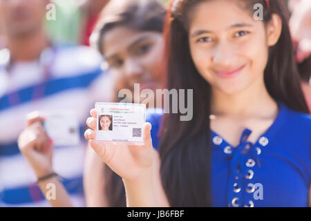 Indian Teenager Girls Showing Aadhaar Card Government Identity Stock Photo