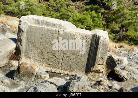 Stone with ancient Greek script. Ruins of temple of Hephaestus on Chimaera Mount. Turkey Stock Photo