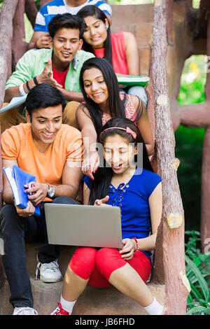 Indian Group College Girls And Boys Student Friends Sharing Laptop Study Education Learning In Park Stock Photo