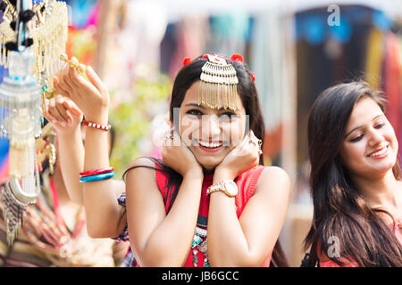 Smiling young Indian friends wearing party hats having fun and enjoying the  party outdoors Stock Photo - Alamy