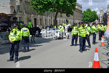 London, UK. 9th June, 2017. People gather outside Downing Street as Theresa May goes to Buckingham Palace. Police keep the area clear as her motorcade returns Credit: PjrNews/Alamy Live News Stock Photo
