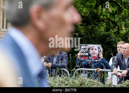 London, UK. 9th June, 2017. Anti Theresa May protester displays placard demanding her resignation following the UK General Election. Stock Photo