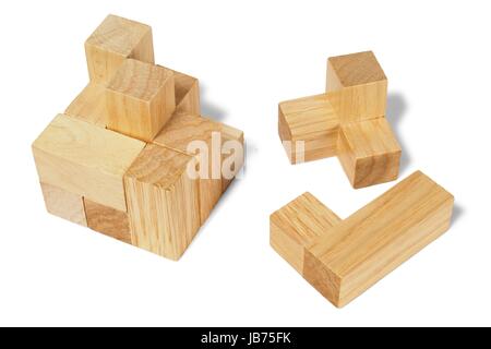 Wooden logic puzzle on white background Stock Photo