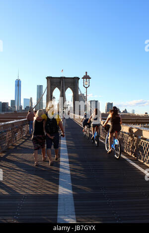 NEW YORK, SEPTEMBER 05: Pedestrians and tourists in Famous historic Brooklyn Bridge in Manhattan over Hudson River in September 05, 2013 in New York. Stock Photo
