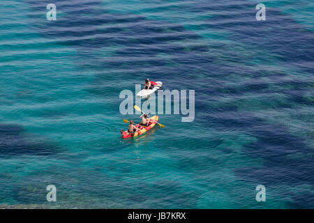 People on a kayak aerial view, people on vacation doing kayak activity on a tranquil blue sea Stock Photo