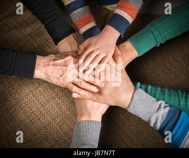 Many hands together. Interior shot Stock Photo