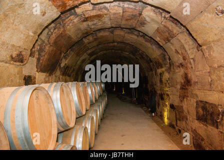 Wooden wine barrels in a wine cellar Stock Photo