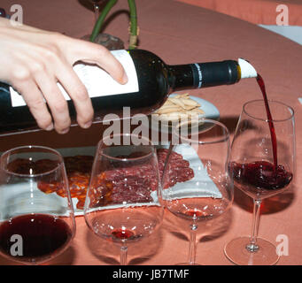 Serving red wine in glasses Stock Photo