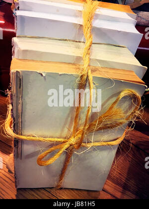 Stack of Coverless Books Tied with Twine Stock Photo