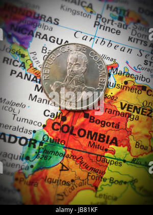 Colombian Coin on World Map Still Life Stock Photo