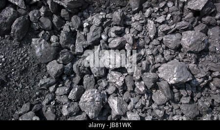 Lumps of coal of varying sizes in pile on ground, near Dali, Yunnan, China Stock Photo