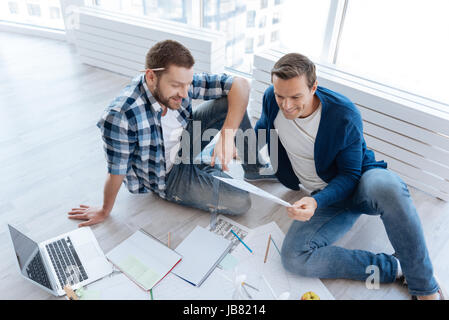 Cheerful male engineers working in team Stock Photo