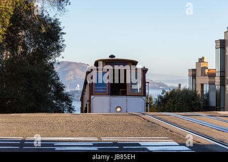 A view of a cable car cresting a hill in San Francisco Stock Photo