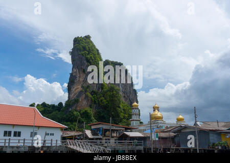 The fishing village of Koh Panyee and dramatic karst rising behind it Stock Photo