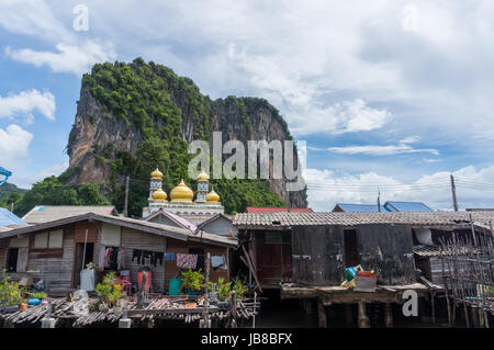 The fishing village of Koh Panyee and dramatic karst rising behind it Stock Photo