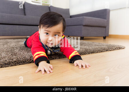 Little boy creeping on floor Stock Photo