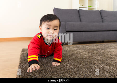 Baby boy creeping on carpet Stock Photo