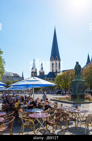 Bonn, Germany. Cafe in front of Bonn Minster (Bonner Münster) in the city centre, Münsterplatz,  Bonn, Germany Stock Photo