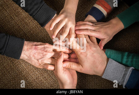 Many hands together. Interior shot Stock Photo