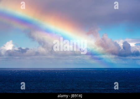 Rainbow and squall over the Pacific Ocean, Hanalei, Kauai, Hawaii USA Stock Photo