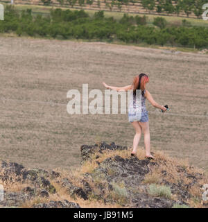 Young lady climbing Lizard Butte (taken from above) Stock Photo