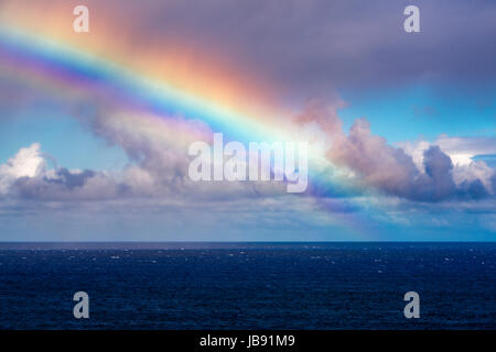 Rainbow and squall over the Pacific Ocean, Hanalei, Kauai, Hawaii USA Stock Photo