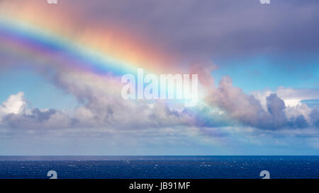 Rainbow and squall over the Pacific Ocean, Hanalei, Kauai, Hawaii USA Stock Photo