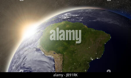 Sunset over South America region on planet Earth viewed from space with Sun and stars in the background. Elements of this image furnished by NASA. Stock Photo