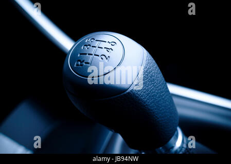 Interior of car, vehicle with visible lever of manual  transmission, with metal, chrome elements. Stock Photo