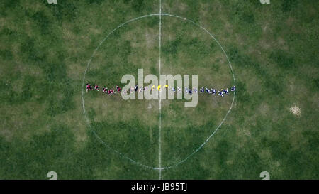image of a soccer field with irregilar circle of center with players, aerial view,drone photography Stock Photo